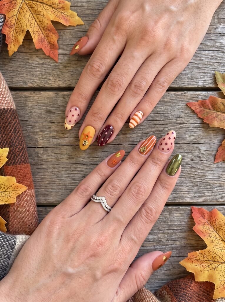 Creative autumn leaf and pumpkin pattern manicure showcasing seasonal Chicago nail ideas