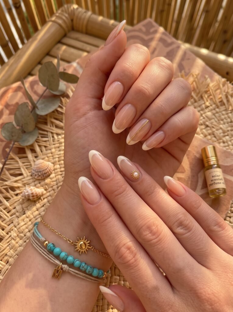 Elegant corporate French tips with gold sun accents showcasing sophisticated summer nail ideas