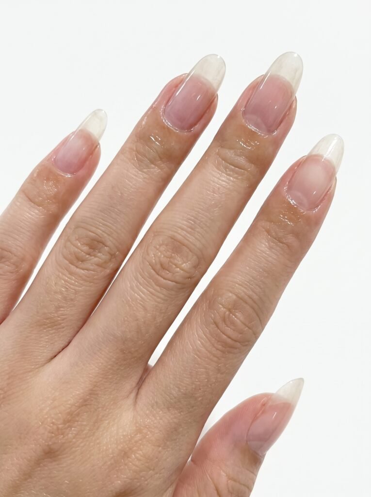 A professional application of protective top coat over a secure nail glue bond