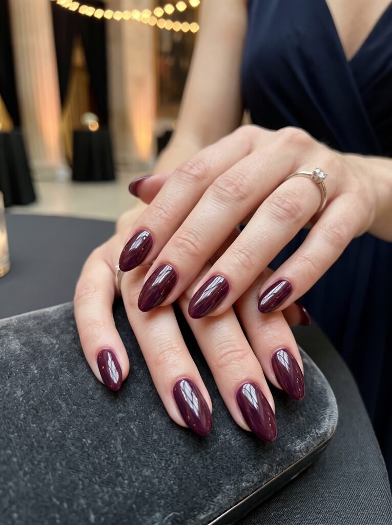 High-shine dark plum and cherry cola gel glaze manicure showcasing good fall nail colors streeterville at NailàCarte.