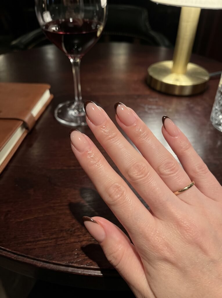 Ultra-thin dark espresso micro-French tips featuring elegant fall nail colors west loop at NailàCarte.