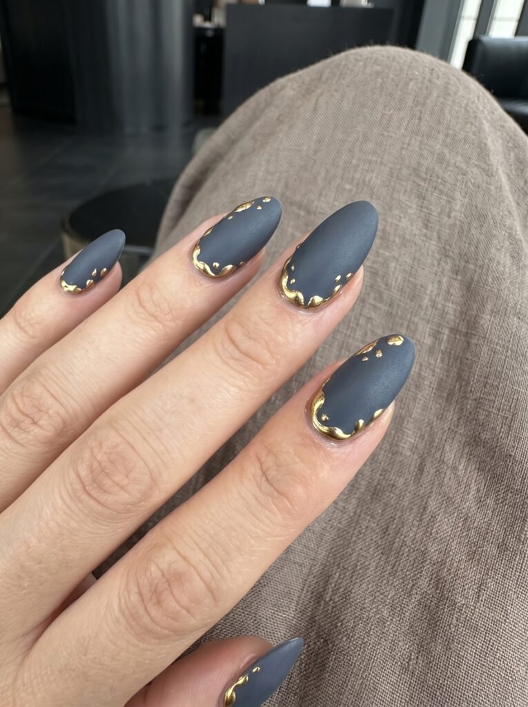 Velvet matte taupe base with 3D liquid molten gold accents for classy nail designs River North at NailàCarte.