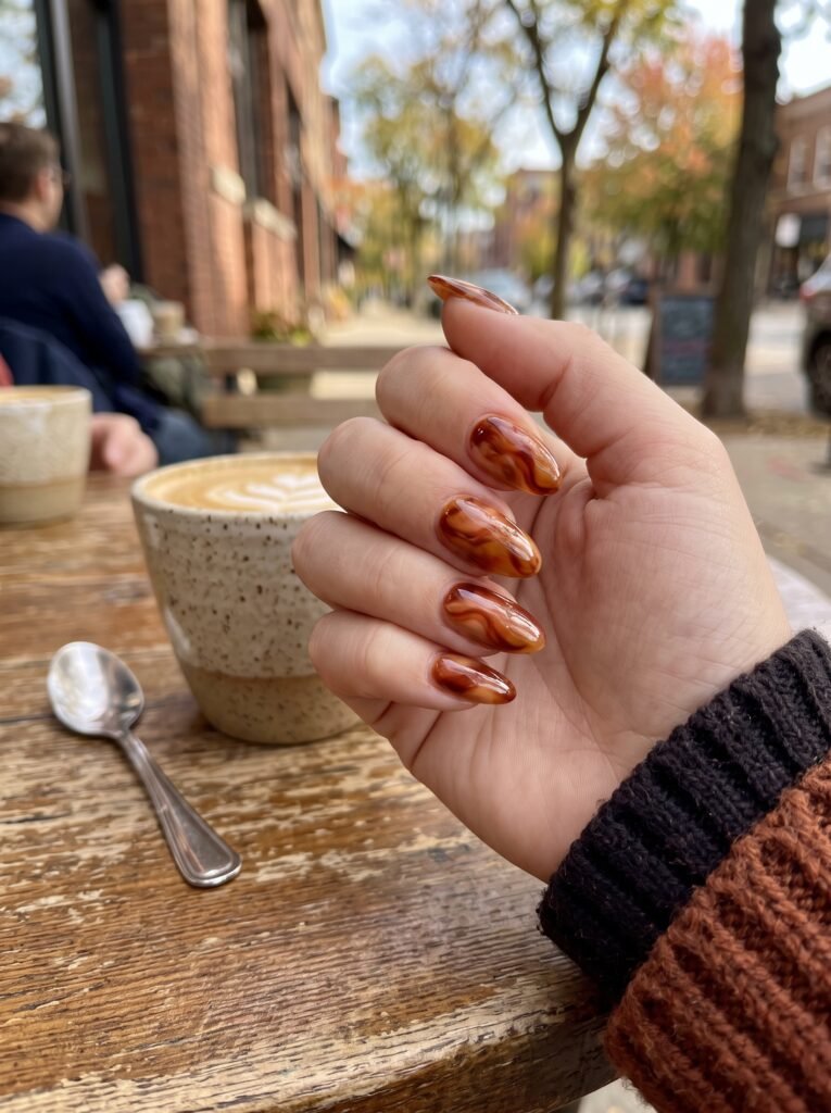 Burnt sienna and amber jelly gel swirls showcasing artistic september nail ideas Wicker Park.