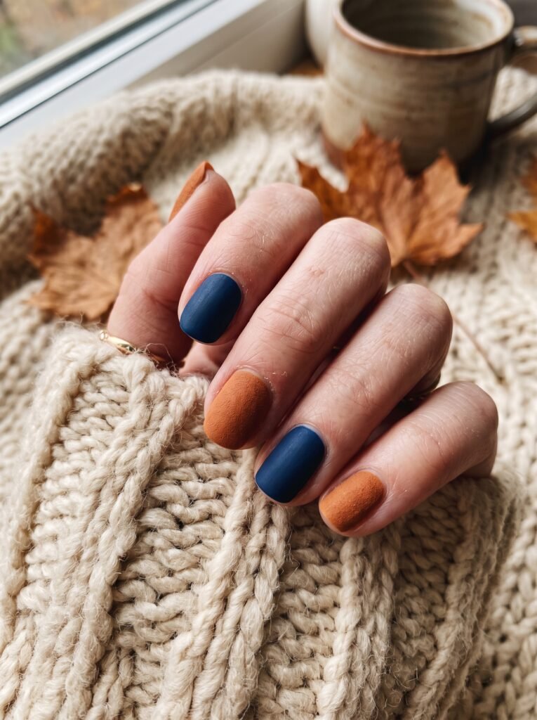 Matte navy and warm cinnamon color-block manicure showcasing autumnal Chicago Bears nail designs.