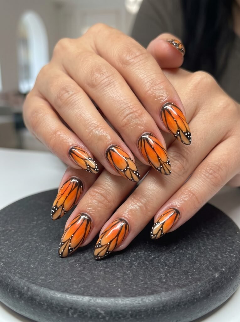 Burnt orange Monarch butterfly wing design showcasing top nail colors for fall 2026 at NailàCarte.