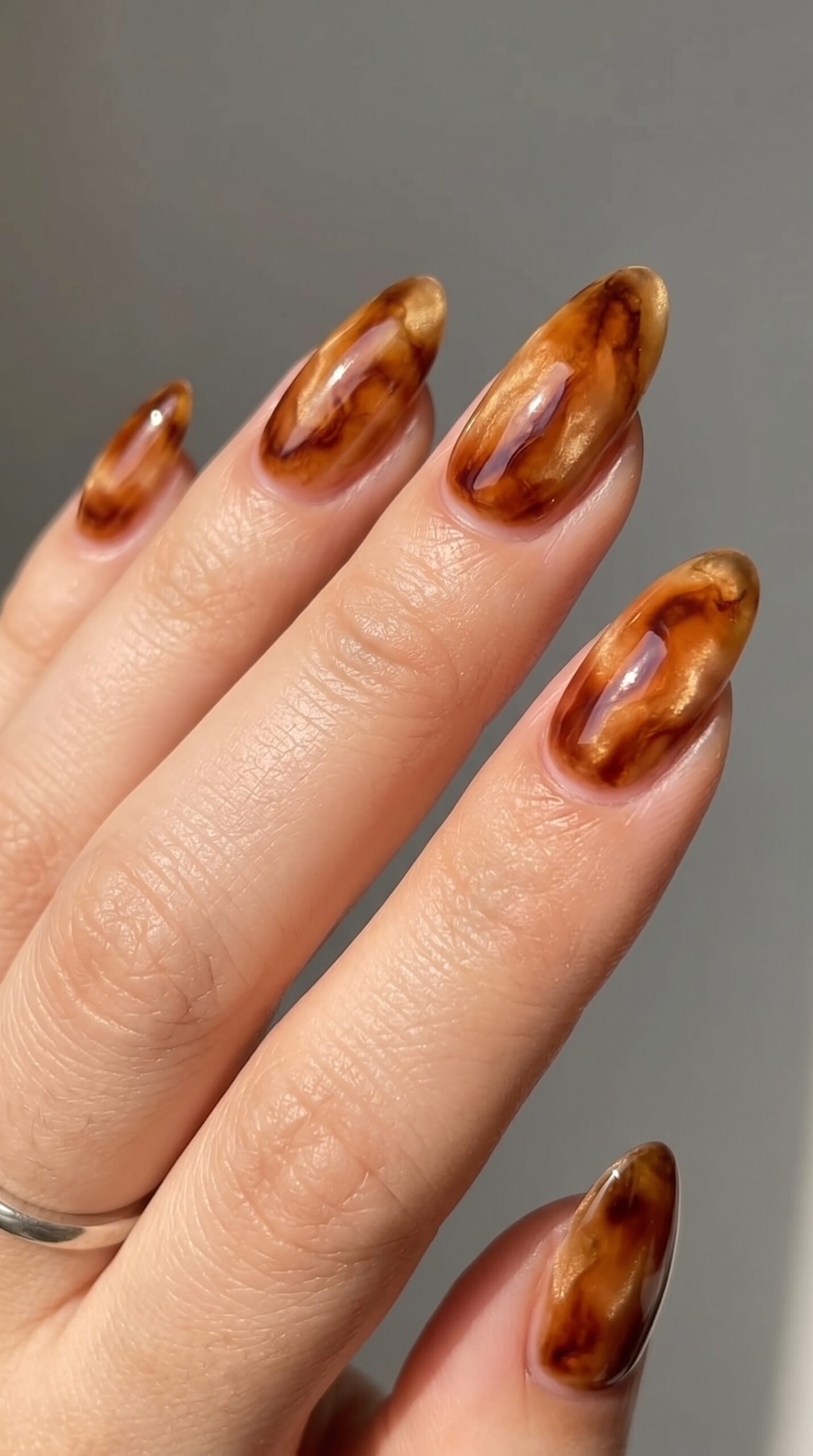 Glazed spiced amber chrome pedicure creating a candlelit glow for vibrant fall toe nail colors.