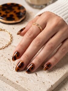 Minimalist tortoiseshell and warm amber accent nail art at NailàCarte Gold Coast.