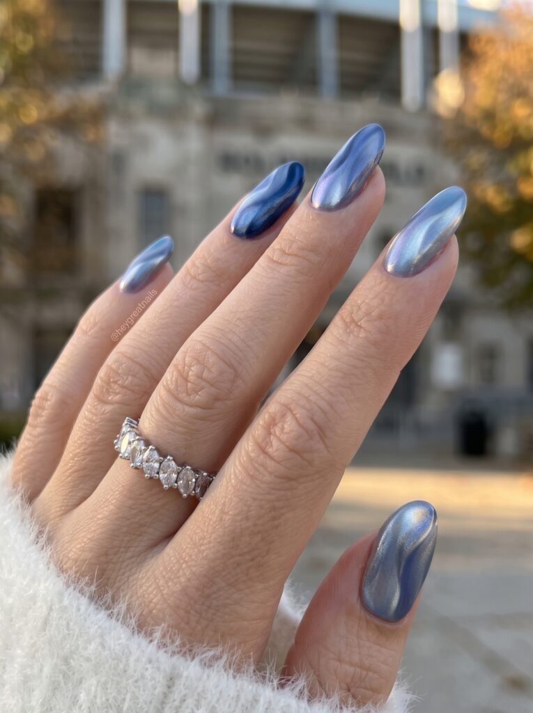 Luminous sheer navy chrome pearl gel manicure featuring elegant Chicago Bears nail designs.