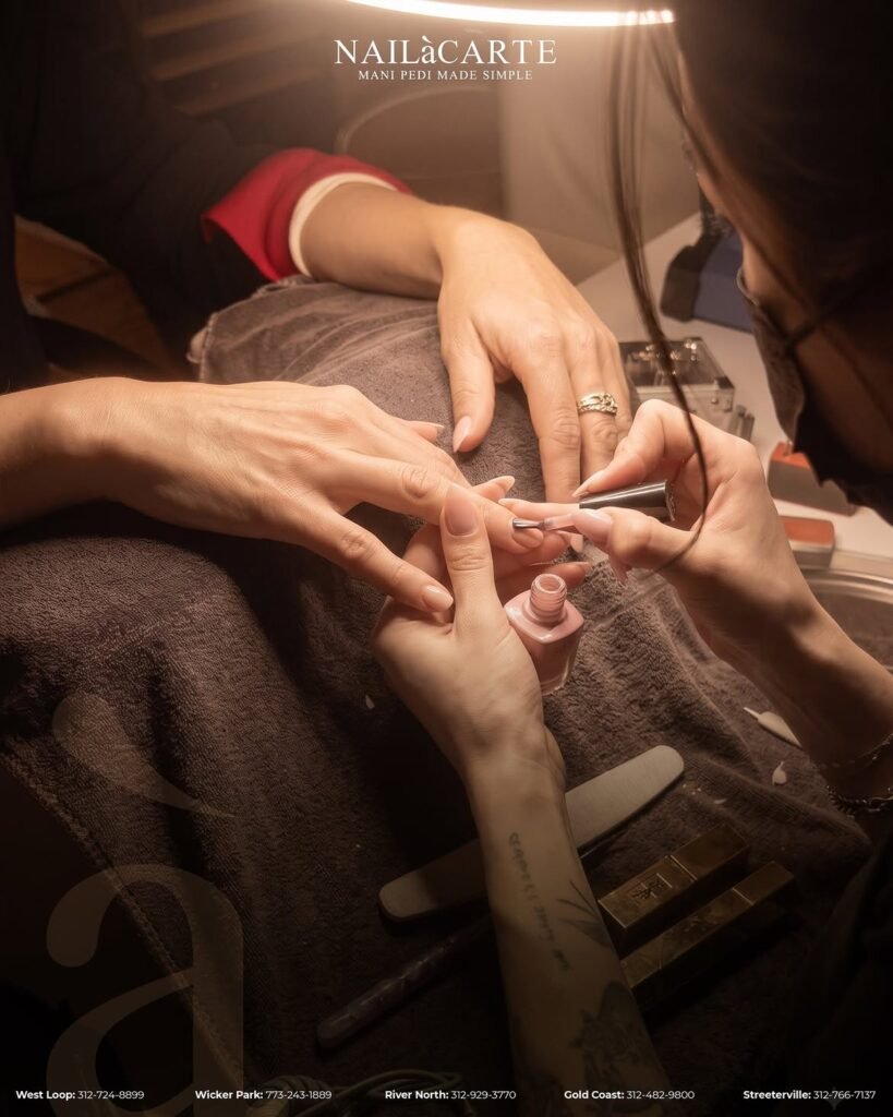 A master manicurist performing a precision manicure Chicago service with detailed e-file prep at NailàCarte