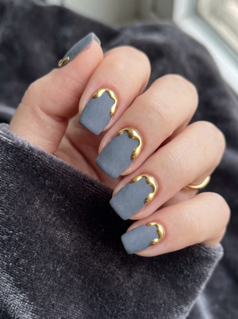 3D liquid molten gold drips over a velvety matte slate-grey dip powder base.