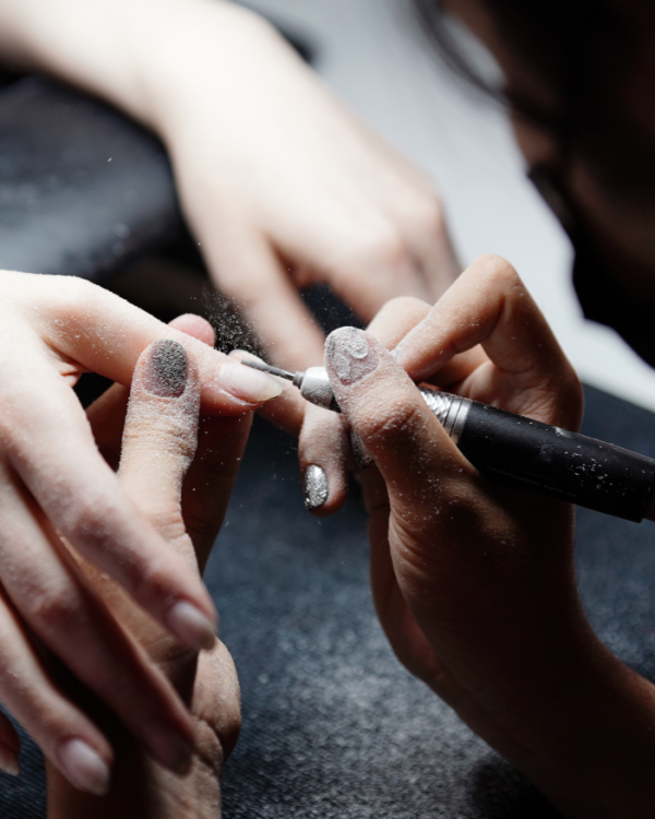 Precision nail art manicure in progress at Nail à Carte, focusing on detailed nail design and professional techniques.